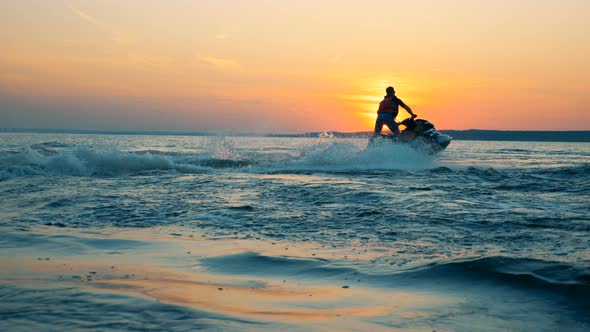 Man Jumps, Riding a Waverunner