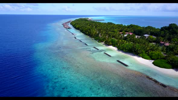 Aerial drone shot texture of paradise seashore beach break by blue lagoon with white sandy backgroun