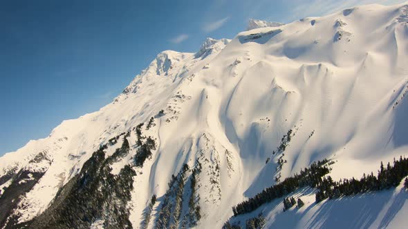 Gigantic Huge Snowy Mountain Aerial Mt Baker Epic Terrain North Cascade Mountains Sunny Blue Skies