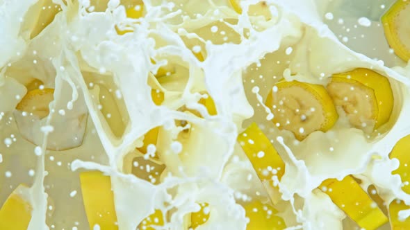 Super Slow Motion Shot of Fresh Banana Cuts Falling Into Cream at 1000Fps