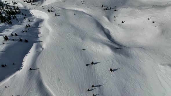 Snowmobile high in the mountains aerial view 4 K