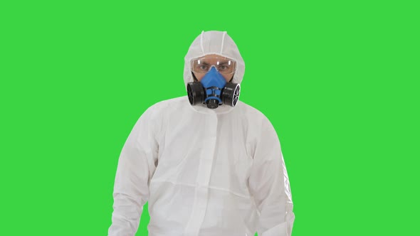 Man Wearing Hazmat Suit Walking on a Green Screen, Chroma Key.