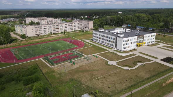 Residential Buildings Near School and Sports Ground