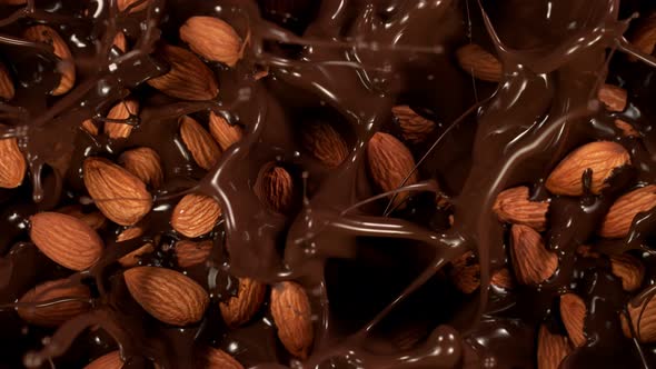 Super Slow Motion Shot of Almonds Falling Into Melted Chocolate at 1000 Fps