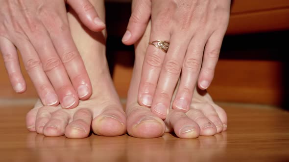 Close Up Female Hands Massage Tired Toes Feet Ankles After a Walk