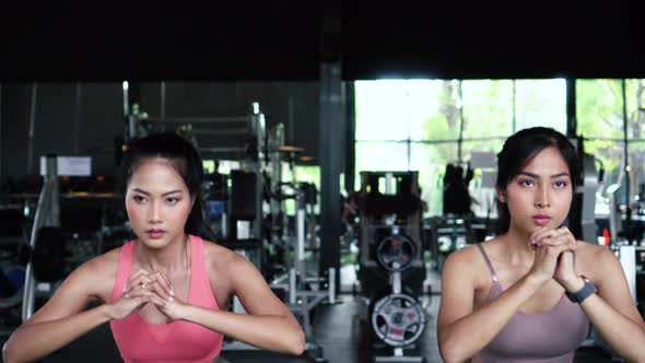 Group of Athletic Young Asian People in Sportswear Doing Squat and Exercising at the Gym