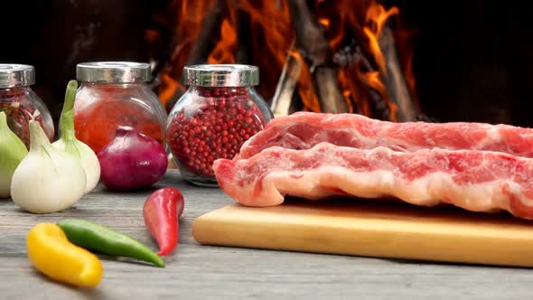 Raw Ribs are Laying on the Wooden Board Next to Ingredients