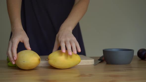 Slowmotion Shot of a Young Woman Lays Out Tropical Fruits on the Table