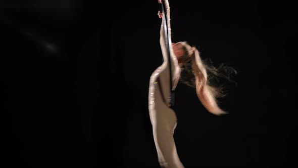 Wide Shot Slim Caucasian Woman in Costume Performing Aerial Acrobatics Spinning Hanging on Air Hoop