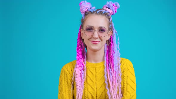 Stylish Young Woman with Colorful Hair and Afro Braids Looking in Camera