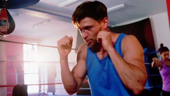 Boxers practicing in boxing ring