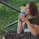 Charming Girl Sitting in Armchair Drinking Tea Outdoor - VideoHive Item for Sale