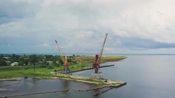 Two Old Rusty Cranes in the Seaport