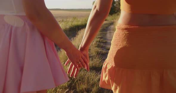 The Girls Held Hands While Walking in Nature