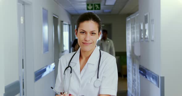 Female doctor standing in the corridor at hospital 4k