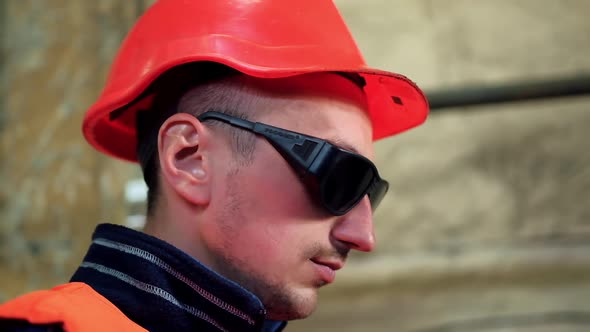 Industrial worker cutting metal. Heavy industry worker cutting steel sheet