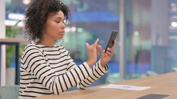 African Woman Using Smartphone in Office