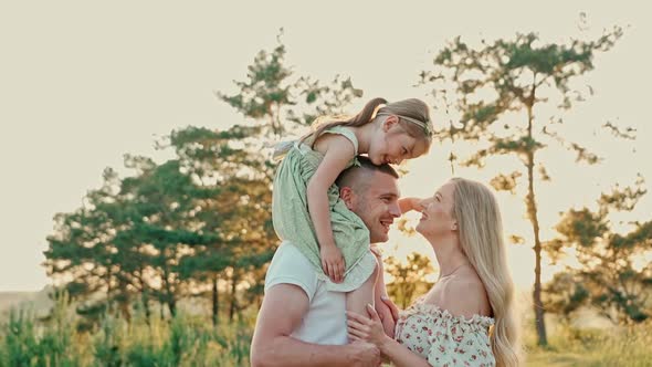 Young Married Couple with Cute Girl Spend Time Together Outdoors 