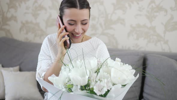 Woman with Bouquet of Flowers Shares Her Impressions By Phone