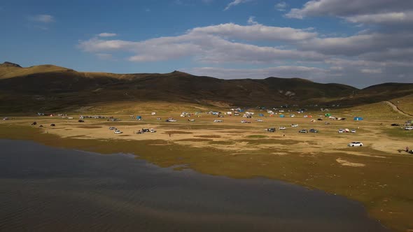 Aerial View From Behind ATVs by Lake and Mountain