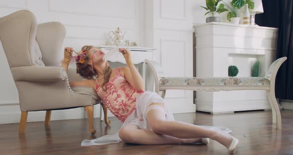 Stunning Royal Lady in Pink and White Clothes Is Sitting on the Floor