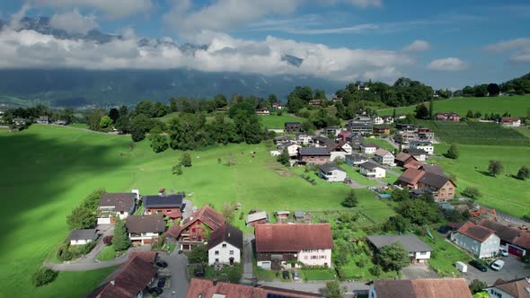 Aerial View of Liechtenstein with Houses on Green Fields in Alps Mountain Valley