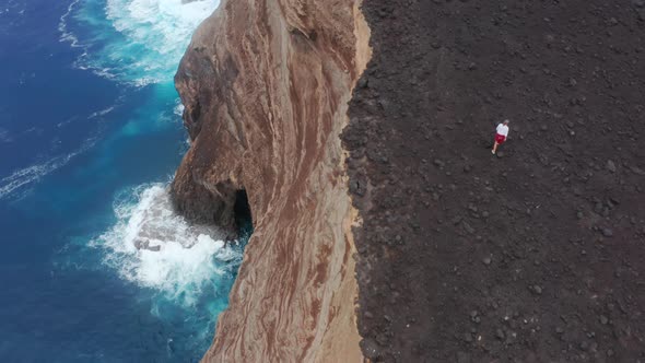 Tourist Explores Isolated Coastal Landscape