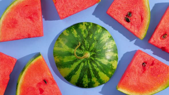 Fresh ripe watermelon slices on blue background.