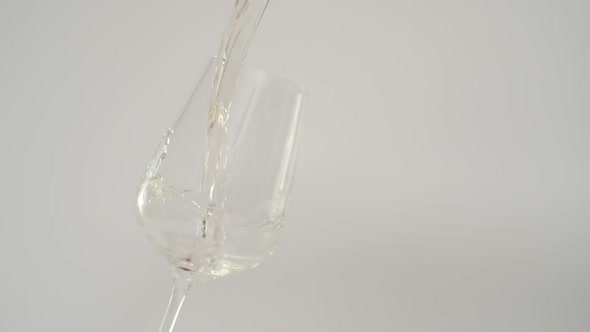 Slow Motion of Pouring White Wine in Tilted Glass at 1000 Fps