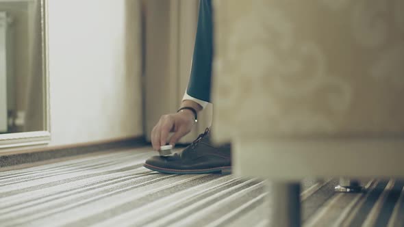 Young Man Cleans His Shoes, Closeup