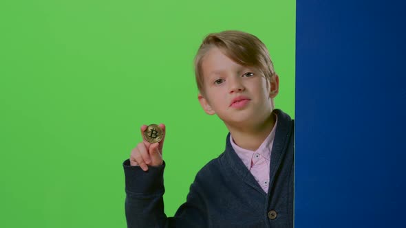 Teenager Comes Out From Behind the Wall Shows the Coin and the Trumb Up on a Green Screen