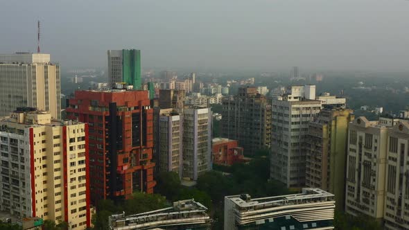 Forward Aerial Pan of Tall Buildings in New Delhi on a Foggy Day