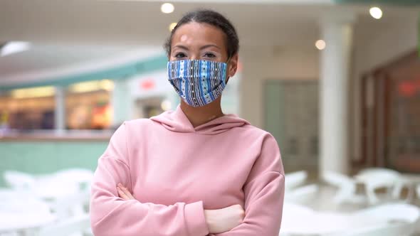 Black African American Woman with Vitiligo Pigmentation Skin Problem Indoor Dressed Pink Hoodie and