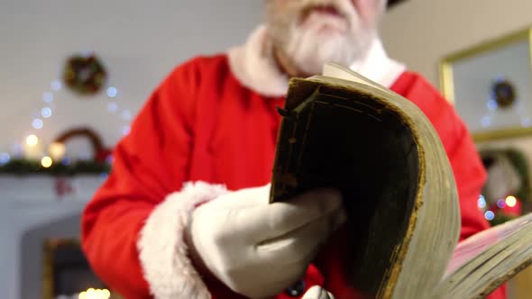 Santa claus reading a list during christmas time