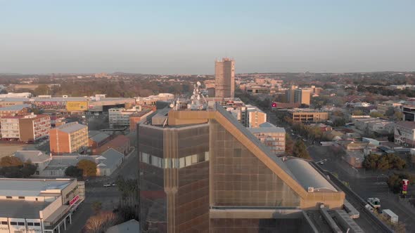 Aerial shot of Reflective Glass Building in city with blue sky