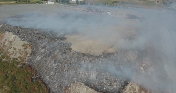 Burning Dump Site Producing Smoke 