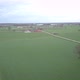 Aerial View of a Field with a Winding Asphalt Country Road Shot with a Drone - VideoHive Item for Sale