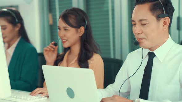 Business People Wearing Headset Working Actively in Office