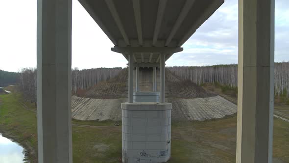 Flight Between the Supports of the Road Bridge Over the River