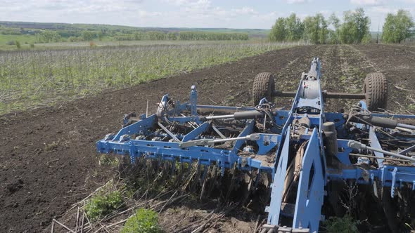 Disking the soil. Short disc harrow.