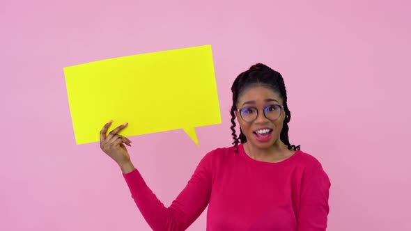 Cute Young African American Girl Stands with Posters for Expression on a Solid Pink Background