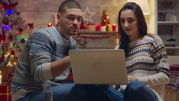 Young Family Doing Online Shopping on Laptop