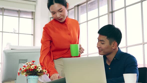 Two Business People Talk Project Strategy at Office