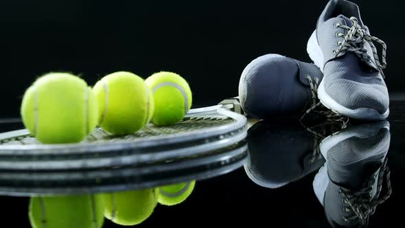 Tennis balls, racket and sports shoe in studio 4k