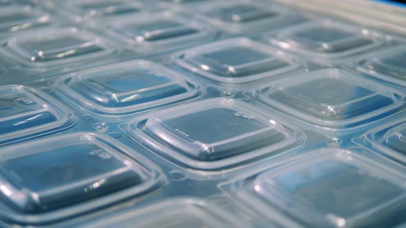 Close Up View of Transparent Plastic Lids Moving Along the Conveyor