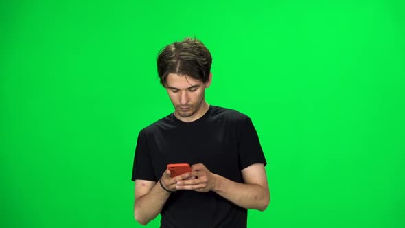 Brunette Guy Goes and Texting on the Phone, Chroma Key. Slow Motion