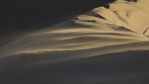 Close up of sand blowing in the wind in slow motion on a giant sand dune in the Little Sahara Nation