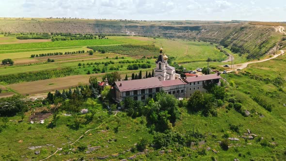 Aerial drone view of a monastery in a valley, located on a hill in Moldova