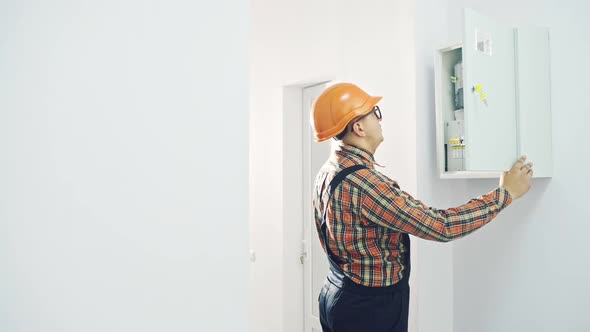 Man Inspecting Fuse Box