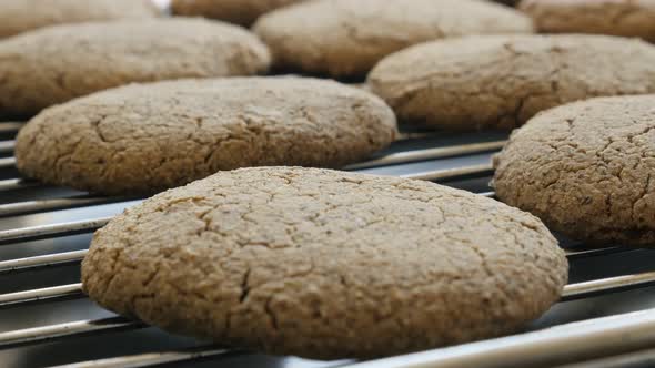 Tilting on buckwheat bread product on baking oven rack 4K 2160p 30fps UltraHD footage - Close-up of 